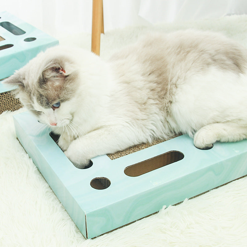 Cat using the PawPuzzle™ rectangle interactive scratching board for play and scratching.